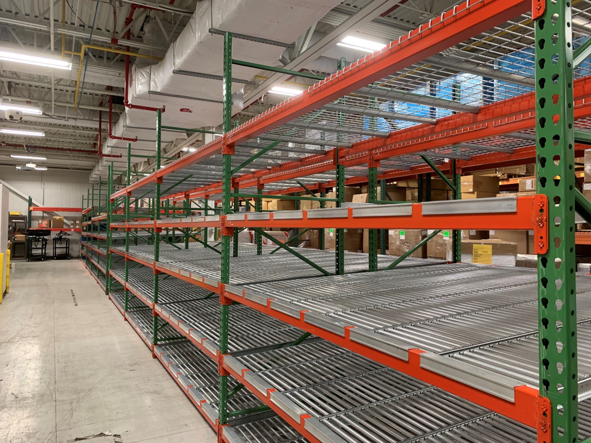 Carton flow rack installation with gravity roller tracks